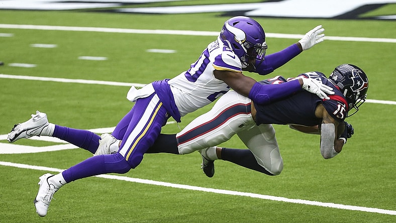 Oct 4, 2020; Houston, Texas, USA; Houston Texans wide receiver Will Fuller (15) makes a reception against Minnesota Vikings cornerback Jeff Gladney (20) during the third quarter at NRG Stadium. Mandatory Credit: Troy Taormina-USA TODAY Sports