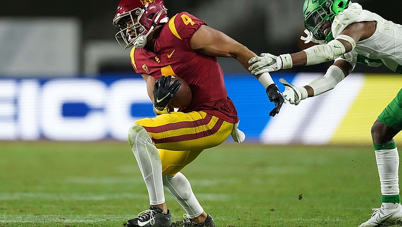 Dec 18, 2020; Los Angeles, California, USA; Southern California Trojans wide receiver Bru McCoy (4) is defended by Oregon Ducks cornerback Mykael Wright (2) during the Pac-12 Championship at United Airlines Field at Los Angeles Memorial Coliseum. Oregon defeated USC 31-24. Mandatory Credit: Kirby Lee-USA TODAY Sports