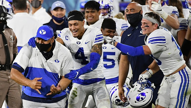 Dec 22, 2020; Boca Raton, Florida, USA; Brigham Young Cougars head coach Kalani Sitake celebrates with defensive back Troy Warner (4) after defeating the UCF Knights at FAU Stadium. Mandatory Credit: Jasen Vinlove-USA TODAY Sports