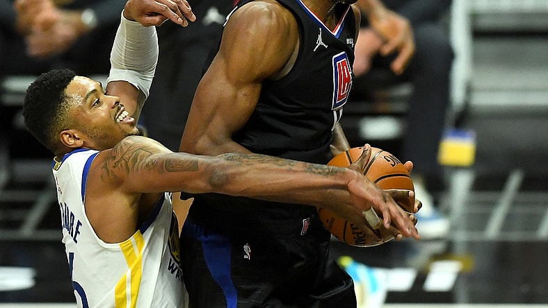 Mar 11, 2021; Los Angeles, California, USA;  Los Angeles Clippers center Serge Ibaka (9) is fouled by Golden State Warriors forward Kent Bazemore (26) as he goes up for a basket in the second half of the game at Staples Center. Mandatory Credit: Jayne Kamin-Oncea-USA TODAY Sports