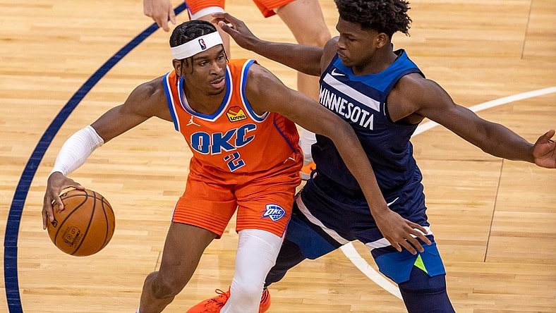 Mar 22, 2021; Minneapolis, Minnesota, USA; (Oklahoma City Thunder guard Shai Gilgeous-Alexander (2) dribbles the ball as Minnesota Timberwolves forward Anthony Edwards (1) plays defense in the second half at Target Center. Mandatory Credit: Jesse Johnson-USA TODAY Sports