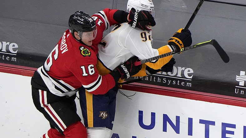 Apr 21, 2021; Chicago, Illinois, USA; Chicago Blackhawks defenseman Nikita Zadorov (16) checks Nashville Predators center Ryan Johansen (92) during the second period at the United Center. Mandatory Credit: Mike Dinovo-USA TODAY Sports