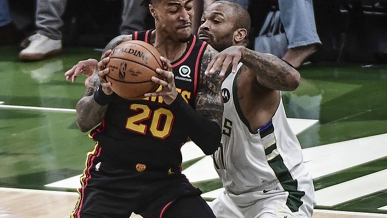 Jul 1, 2021; Milwaukee, Wisconsin, USA; Atlanta Hawks forward John Collins (20) gets pressure from Milwaukee Bucks forward P.J. Tucker (17) in the first quarter during game five of the Eastern Conference Finals for the 2021 NBA Playoffs at Fiserv Forum. Mandatory Credit: Benny Sieu-USA TODAY Sports