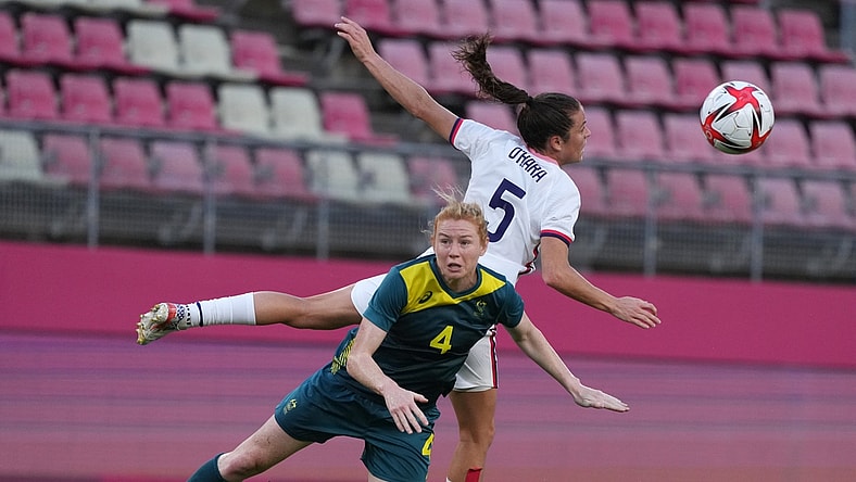 Jul 27, 2021; Ibaraki, Japan; Australia player Clare Polkinghorne (4) and USA player Kelley O'Hara (5) go for a header during the Tokyo 2020 Olympic Summer Games at Ibaraki Kashima Stadium. Mandatory Credit: Jack Gruber-USA TODAY Sports