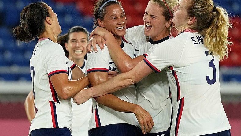 Jul 30, 2021; Yokohama, Japan; Team United States forward Lynn Williams (21) is congratulated after scoring against the Netherlands by midfielder Lindsey Horan (9) and forward Carli Lloyd (left) during the first half in a women's quarterfinals match during the Tokyo 2020 Olympic Summer Games at International Stadium Yokohama. Mandatory Credit: Jack Gruber-USA TODAY Sports