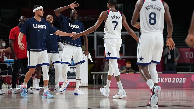 Jul 31, 2021; Saitama, Japan; Team United States guard Devin Booker (15) and Team United States centre Draymond Green (14) celebrate with Team United States forward Kevin Durant (7) at the end of the third quarter against Czech Republic during the Tokyo 2020 Olympic Summer Games at Saitama Super Arena. Mandatory Credit: Kareem Elgazzar-USA TODAY Sports