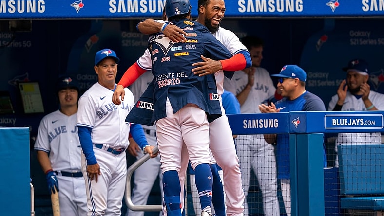 Aug 1, 2021; Toronto, Ontario, CAN; Toronto Blue Jays second baseman Santiago Espinal (5) hugs teammate Teoscar Hernandez (37) after hitting a home run against the Kansas City Royals during the fourth inning at Rogers Centre. Mandatory Credit: Kevin Sousa-USA TODAY Sports