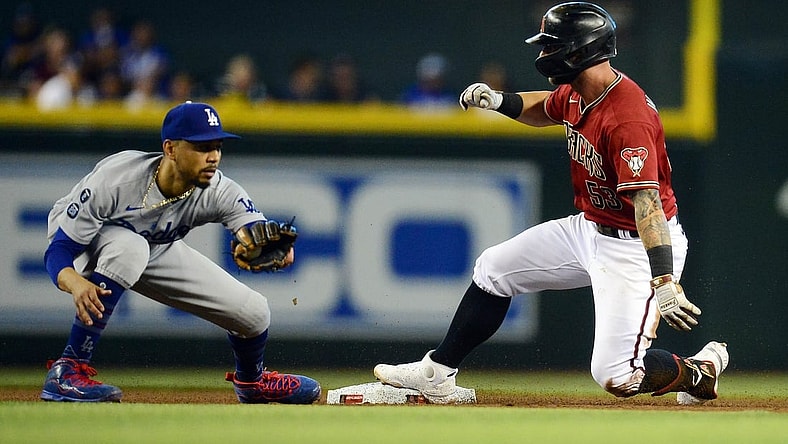 Aug 1, 2021; Phoenix, Arizona, USA; Arizona Diamondbacks first baseman Christian Walker (53) reaches second against Los Angeles Dodgers second baseman Mookie Betts (50) after hitting a single during the fourth inning at Chase Field. Mandatory Credit: Gary A. Vasquez-USA TODAY Sports