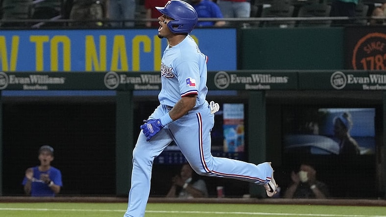 Aug 1, 2021; Arlington, Texas, USA; Texas Rangers second baseman Andy Ibanez (77) celebrates as he rounds the bases on his two-run home run to tie the game against the Seattle Mariners during the ninth inning of a baseball game at Globe Life Field. Mandatory Credit: Jim Cowsert-USA TODAY Sports