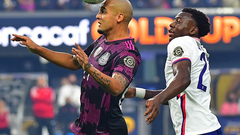 Aug 1, 2021; Las Vegas, Nevada, USA; Mexico defender Luis Rodriguez (21) heads the ball in front of USA defender George Bello (21) during the first half of the CONCACAF Gold Cup final soccer match at Allegiant Stadium. Mandatory Credit: Stephen R. Sylvanie-USA TODAY Sports