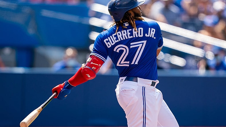 Aug 2, 2021; Toronto, Ontario, CAN; Toronto Blue Jays first baseman Vladimir Guerrero Jr. (27) hits a single against the Cleveland Indians during the first inning at Rogers Centre. Mandatory Credit: Kevin Sousa-USA TODAY Sports