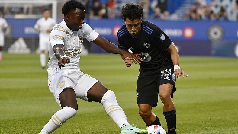 Aug 4, 2021; Montreal, Quebec, CAN; CF Montreal midfielder Joaquin Torres (18) plays the ball as Atlanta United FC defender George Bello (21) defends during the first half at Stade Saputo. Mandatory Credit: Eric Bolte-USA TODAY Sports