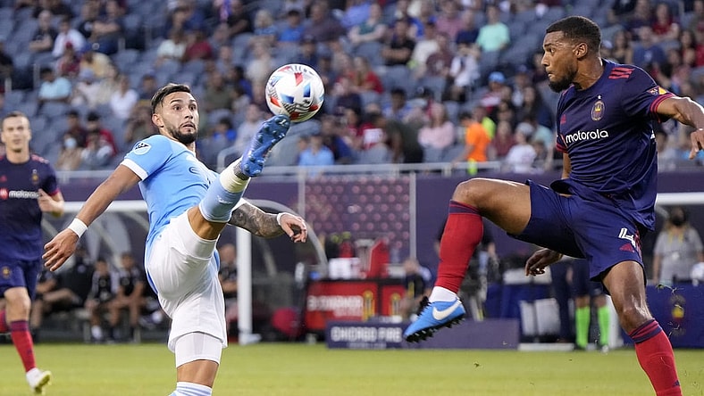 Aug 4, 2021; Chicago, Illinois, USA; New York City midfielder Valentin Castellanos (11) and Chicago Fire defender Johan Kappelhof (4) play for the ball during the first half at Soldier Field. Mandatory Credit: Mike Dinovo-USA TODAY Sports