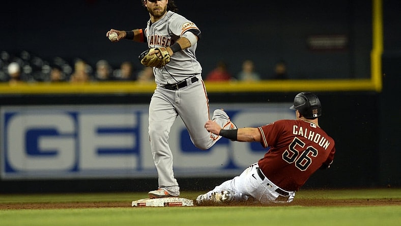 Aug 4, 2021; Phoenix, Arizona, USA; San Francisco Giants shortstop Brandon Crawford (top) forces out Arizona Diamondbacks right fielder Kole Calhoun (56) at second base during the sixth inning at Chase Field. Mandatory Credit: Joe Camporeale-USA TODAY Sports