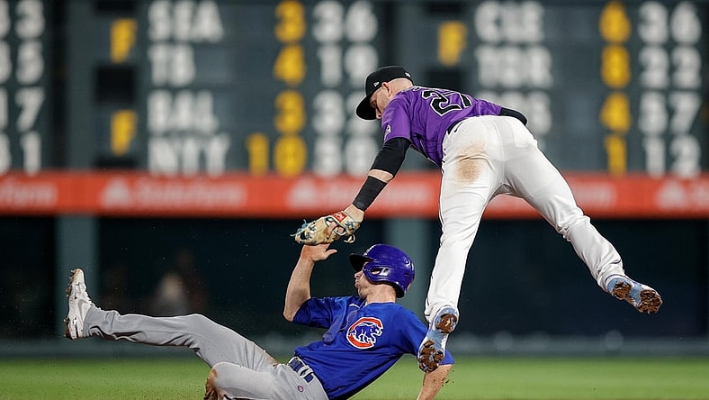 Aug 4, 2021; Denver, Colorado, USA; Chicago Cubs pinch hitter Matt Duffy (5) is tagged out by Colorado Rockies shortstop Trevor Story (27) as he attempts to steal second base in the ninth inning at Coors Field. Mandatory Credit: Isaiah J. Downing-USA TODAY Sports