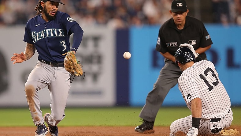 Aug 5, 2021; Bronx, New York, USA; New York Yankees left fielder Joey Gallo (13) slides into second base with a double before Seattle Mariners shortstop J.P. Crawford (3) receives the throw during the fourth inning at Yankee Stadium. Mandatory Credit: Brad Penner-USA TODAY Sports