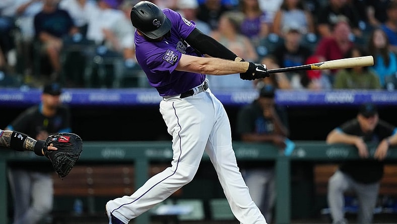 Aug 6, 2021; Denver, Colorado, USA; Colorado Rockies first baseman C.J. Cron (25) hits a three run home run during the fourth inning inning against the against the Miami Marlins at Coors Field. Mandatory Credit: Ron Chenoy-USA TODAY Sports