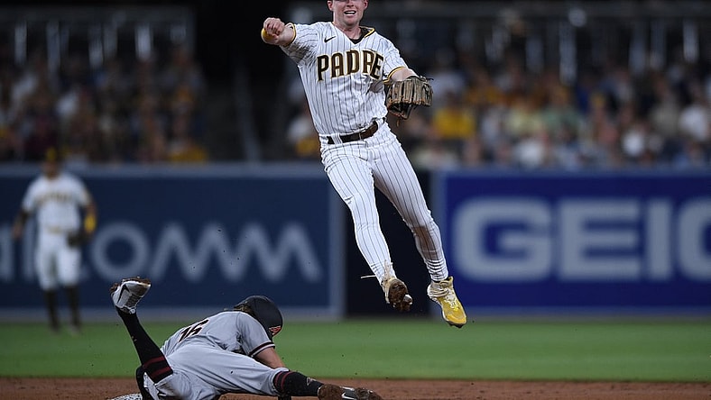 Aug 6, 2021; San Diego, California, USA; San Diego Padres shortstop Jake Cronenworth (top) throws to first base to complete a double play after forcing out Arizona Diamondbacks second baseman Jake Hager (16) at second base during the third inning at Petco Park. Mandatory Credit: Orlando Ramirez-USA TODAY Sports