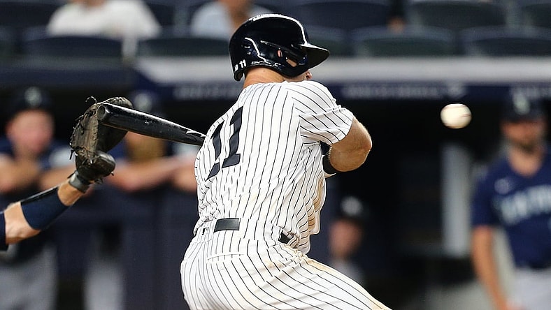 Aug 6, 2021; Bronx, New York, USA; New York Yankees center fielder Brett Gardner (11) hits a game winning walk off RBI single against the Seattle Mariners during the eleventh inning at Yankee Stadium. Mandatory Credit: Andy Marlin-USA TODAY Sports