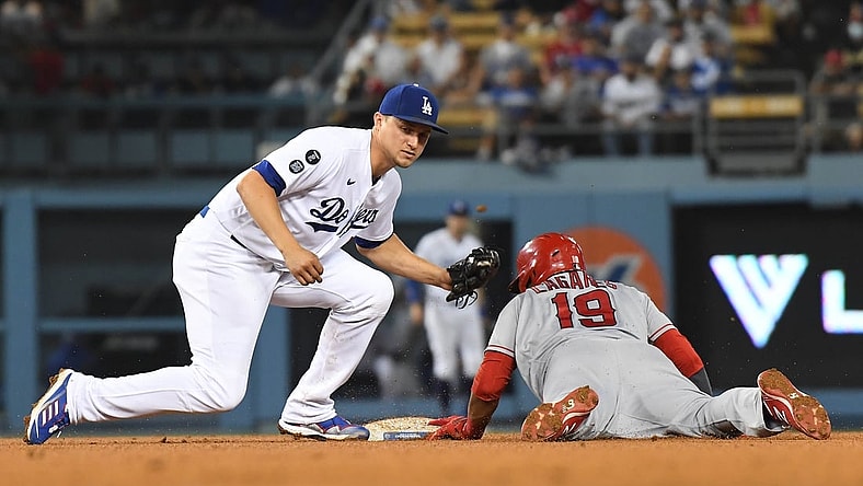 Aug 6, 2021; Los Angeles, California, USA; Los Angeles Angels center fielder Juan Lagares (19) is caught stealing second against Los Angeles Dodgers shortstop Corey Seager (5) during the fifth inning at Dodger Stadium. Mandatory Credit: Richard Mackson-USA TODAY Sports