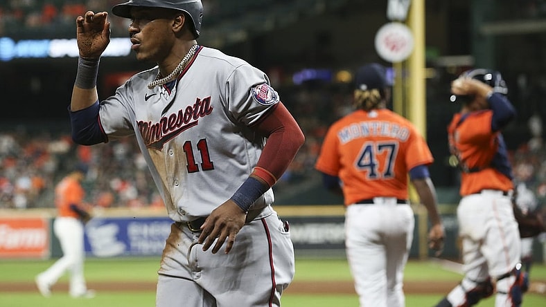 Aug 6, 2021; Houston, Texas, USA;Minnesota Twins designated hitter Jorge Polanco (11) scores a run against the Houston Astros in the eleventh inning at Minute Maid Park. Mandatory Credit: Thomas Shea-USA TODAY Sports