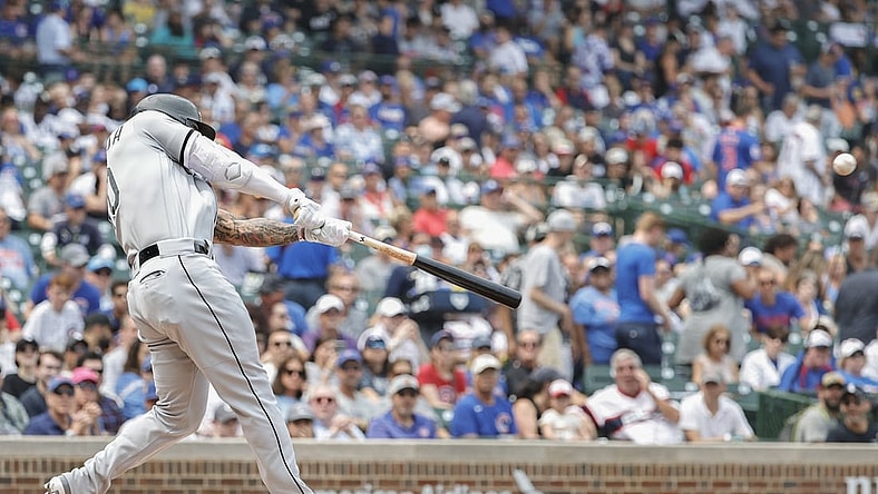 Aug 7, 2021; Chicago, Illinois, USA; Chicago White Sox third baseman Yoan Moncada (10) hits a two-run double against the Chicago Cubs during the first inning at Wrigley Field. Mandatory Credit: Kamil Krzaczynski-USA TODAY Sports