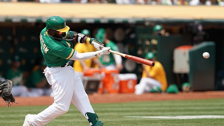 Aug 7, 2021; Oakland, California, USA; Oakland Athletics second baseman Josh Harrison (1) hits a single during the second inning against the Texas Rangers at RingCentral Coliseum. Mandatory Credit: Darren Yamashita-USA TODAY Sports