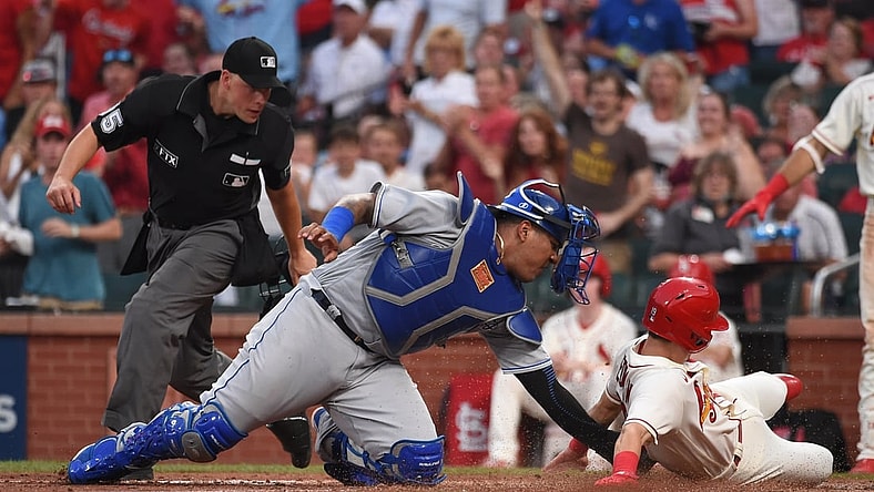 Aug 7, 2021; St. Louis, Missouri, USA; Kansas City Royals catcher Salvador Perez (13) tags out St. Louis Cardinals second baseman Tommy Edman (19) during the fourth inning at Busch Stadium. Mandatory Credit: Joe Puetz-USA TODAY Sports