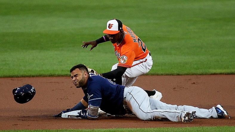 Aug 7, 2021; Baltimore, Maryland, USA; Tampa Bay Rays designated hitter Nelson Cruz (23) slides in safely to second base against Baltimore Orioles shortstop Jorge Mateo (26) during the first inning at Oriole Park at Camden Yards. Mandatory Credit: Daniel Kucin Jr.-USA TODAY Sports