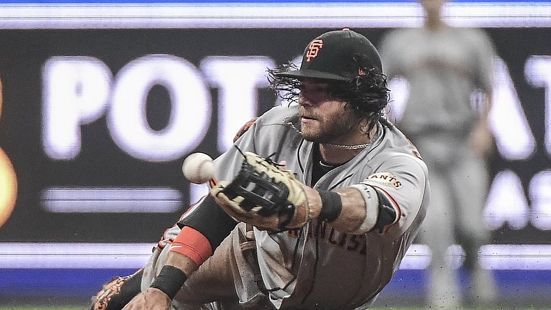 Aug 7, 2021; Milwaukee, Wisconsin, USA;  San Francisco Giants shortstop Brandon Crawford (35) attempts to make a force out on an infield hit by Milwaukee Brewers center fielder Lorenzo Cain (not pictured) in the second inning at American Family Field. Mandatory Credit: Benny Sieu-USA TODAY Sports