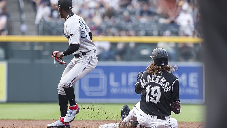 Aug 7, 2021; Denver, Colorado, USA; Colorado Rockies right fielder Charlie Blackmon (19) slides safely into second base past Miami Marlins second baseman Jazz Chisholm Jr. (2) after hitting a double in the second inning at Coors Field. Mandatory Credit: Michael Ciaglo-USA TODAY Sports