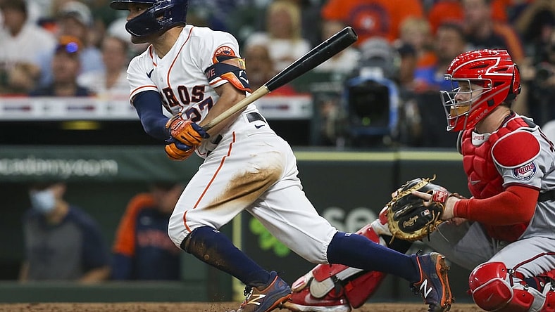 Aug 7, 2021; Houston, Texas, USA; Houston Astros second baseman Jose Altuve (27) hits a single against the Minnesota Twins in the fifth inning at Minute Maid Park. Mandatory Credit: Thomas Shea-USA TODAY Sports