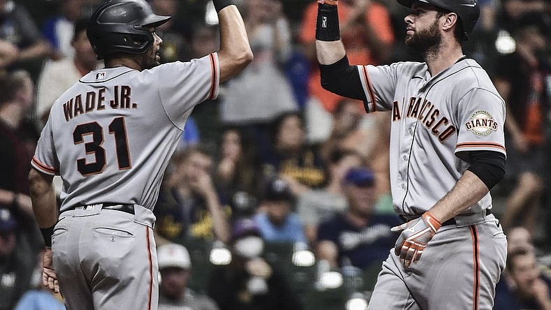 Aug 7, 2021; Milwaukee, Wisconsin, USA; San Francisco Giants first baseman Brandon Belt (9) is greeted by center fielder LaMonte Wade Jr (31) after hitting a two-run home run in the eleventh inning against the Milwaukee Brewers at American Family Field. Mandatory Credit: Benny Sieu-USA TODAY Sports