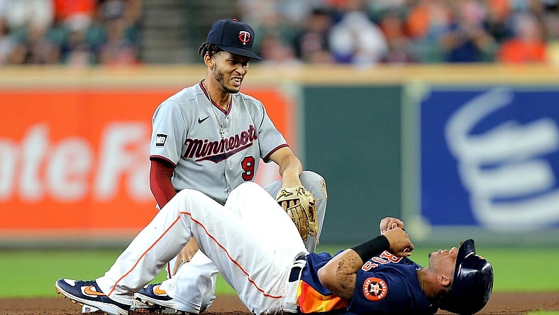 Aug 8, 2021; Houston, Texas, USA; Minnesota Twins shortstop Andrelton Simmons (9) and Houston Astros designated hitter Michael Brantley (23) react after a collision at second base during the first inning at Minute Maid Park. Mandatory Credit: Erik Williams-USA TODAY Sports