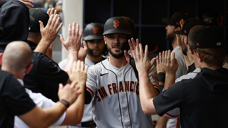 Aug 8, 2021; Milwaukee, Wisconsin, USA;  San Francisco Giants left fielder Kris Bryant (23) high fives teammates after scoring a run during the sixth inning against the Milwaukee Brewers at American Family Field. Mandatory Credit: Jeff Hanisch-USA TODAY Sports