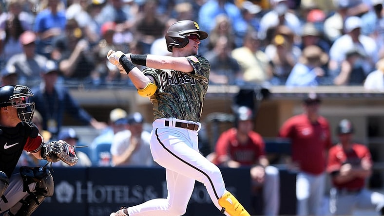 Aug 8, 2021; San Diego, California, USA; San Diego Padres shortstop Jake Cronenworth (9) hits an RBI single against the Arizona Diamondbacks during the first inning at Petco Park. Mandatory Credit: Orlando Ramirez-USA TODAY Sports