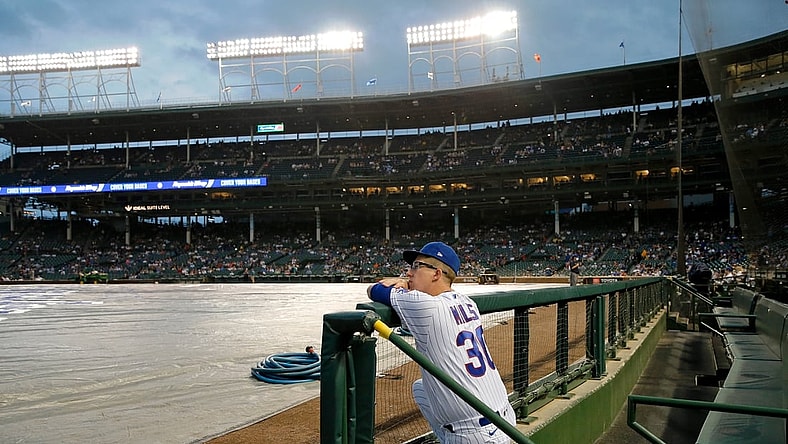 Aug 9, 2021; Chicago, Illinois, USA;  Chicago Cubs starting pitcher Alec Mills (30) leans on the fence in the dugout while looking at the field during a rain delay before the game between the Chicago Cubs and the Milwaukee Brewers at Wrigley Field. Mandatory Credit: Jon Durr-USA TODAY Sports