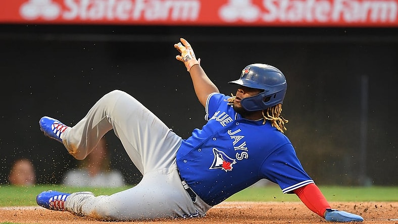 Aug 10, 2021; Anaheim, California, USA;  Toronto Blue Jays first baseman Vladimir Guerrero Jr. beats the throw to Los Angeles Angels catcher Kurt Suzuki (24) to score a run in the first inning of the game at Angel Stadium. Mandatory Credit: Jayne Kamin-Oncea-USA TODAY Sports