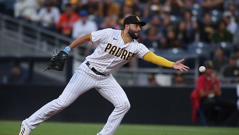 Aug 10, 2021; San Diego, California, USA; San Diego Padres first baseman Eric Hosmer (30) tosses the ball to first base on a ground out by Miami Marlins shortstop Miguel Rojas (not pictured) during the first inning at Petco Park. Mandatory Credit: Orlando Ramirez-USA TODAY Sports