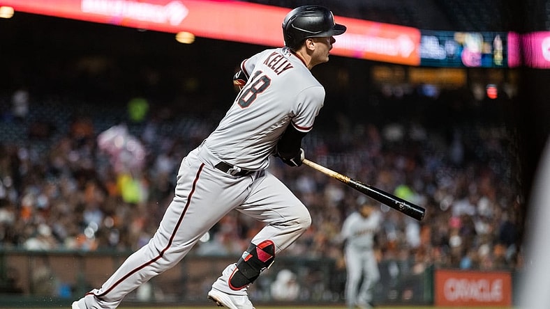 Aug 10, 2021; San Francisco, California, USA; Arizona Diamondbacks catcher Carson Kelly (18) hits a double against the San Francisco Giants in the sixth inning at Oracle Park. Mandatory Credit: John Hefti-USA TODAY Sports
