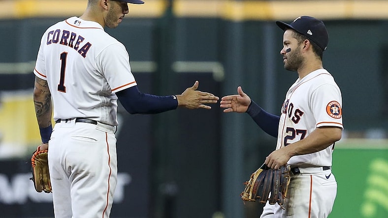 Aug 11, 2021; Houston, Texas, USA; Houston Astros shortstop Carlos Correa (1) and second baseman Jose Altuve (27) celebrate defeating the Colorado Rockies  at Minute Maid Park. Mandatory Credit: Thomas Shea-USA TODAY Sports