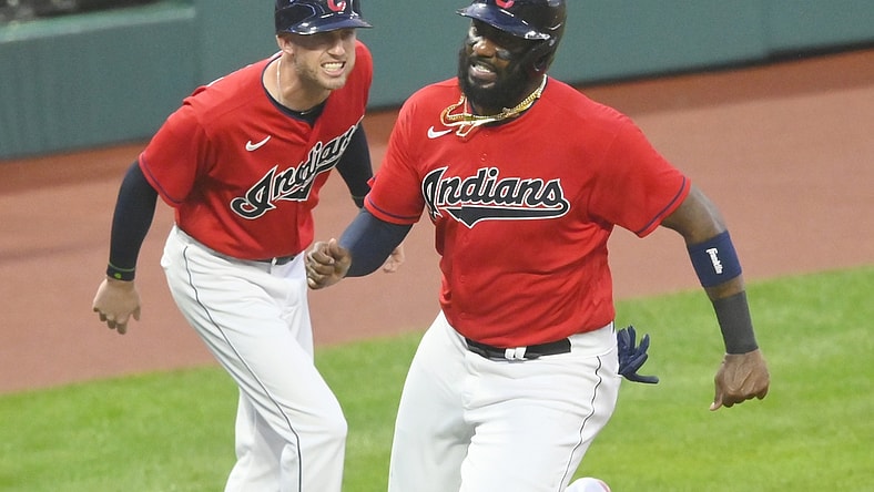 Aug 11, 2021; Cleveland, Ohio, USA; Cleveland Indians third base coach Kyle Hudson (97) yells as designated hitter Franmil Reyes (32) rounds third base before scoring in the first inning against the Oakland Athletics at Progressive Field. Mandatory Credit: David Richard-USA TODAY Sports