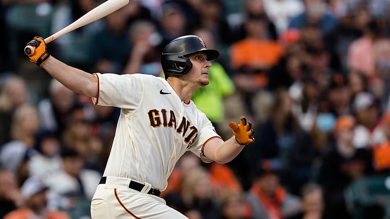 Aug 12, 2021; San Francisco, California, USA; San Francisco Giants left fielder Alex Dickerson (12) hits an RBI double against the Colorado Rockies in the second inning at Oracle Park. Mandatory Credit: John Hefti-USA TODAY Sports