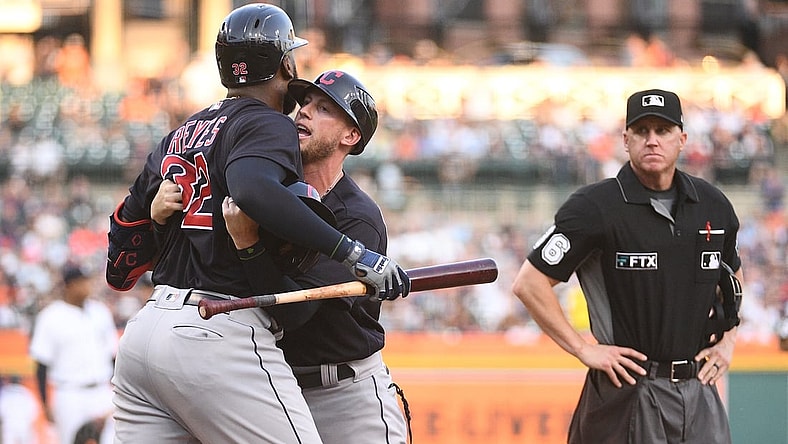 Aug 13, 2021; Detroit, Michigan, USA; Cleveland Indians third base coach Kyle Hudson (97) holds back right fielder Franmil Reyes (32) after being ejected from the game by umpire Ryan Blakney (36) during the third inning against the Detroit Tigers at Comerica Park. Mandatory Credit: Tim Fuller-USA TODAY Sports