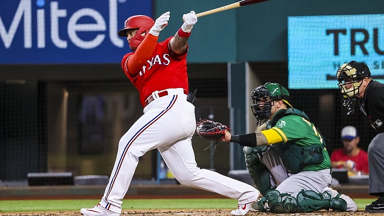 Aug 13, 2021; Arlington, Texas, USA;  Texas Rangers designated hitter Yohel Pozo (37) hits a single for his first major league hit during the second inning against the Oakland Athletics at Globe Life Field. Mandatory Credit: Kevin Jairaj-USA TODAY Sports