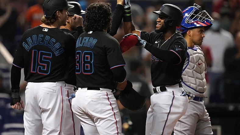 Aug 13, 2021; Miami, Florida, USA; Miami Marlins right fielder Bryan De La Cruz (77) celebrates with teammates after hitting a grand slam home run in the 2nd inning against the Chicago Cubs at loanDepot park. Mandatory Credit: Jasen Vinlove-USA TODAY Sports