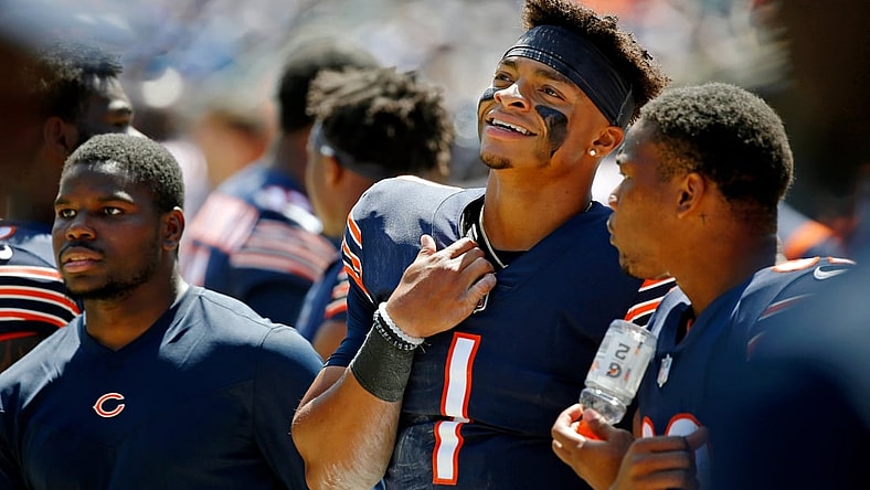 Aug 14, 2021; Chicago, Illinois, USA; Chicago Bears quarterback Justin Fields (1) smiles while watching the game against the Miami Dolphins during the first half at Soldier Field. Mandatory Credit: Jon Durr-USA TODAY Sports