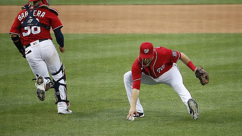 Aug 14, 2021; Washington, District of Columbia, USA; Washington Nationals third baseman Carter Kieboom (8) picks up a ground ball and throws to first against the Atlanta Braves in the fifth inning at Nationals Park. Mandatory Credit: Amber Searls-USA TODAY Sports