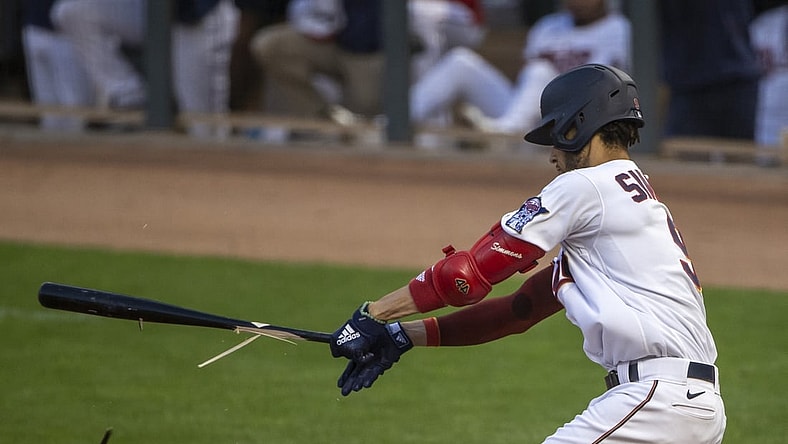Aug 16, 2021; Minneapolis, Minnesota, USA; Minnesota Twins shortstop Andrelton Simmons (9) hits a ground ball and breaks his bat in the second inning against the Cleveland Indians at Target Field. Mandatory Credit: Jesse Johnson-USA TODAY Sports