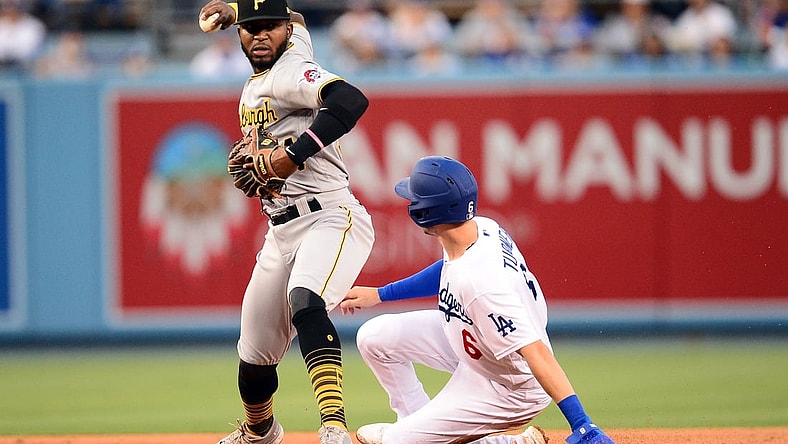 Aug 16, 2021; Los Angeles, California, USA; Los Angeles Dodgers shortstop Trea Turner (6) is out at second as Pittsburgh Pirates second baseman Rodolfo Castro (64) throws to first for the out against first baseman Albert Pujols (55) during the first inning at Dodger Stadium. Mandatory Credit: Gary A. Vasquez-USA TODAY Sports